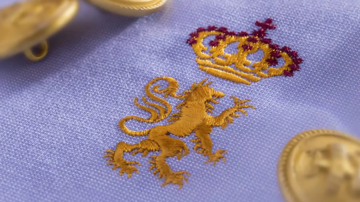 Crown and lettering embroidered on purple fabric using Madeira Classic 60 thread